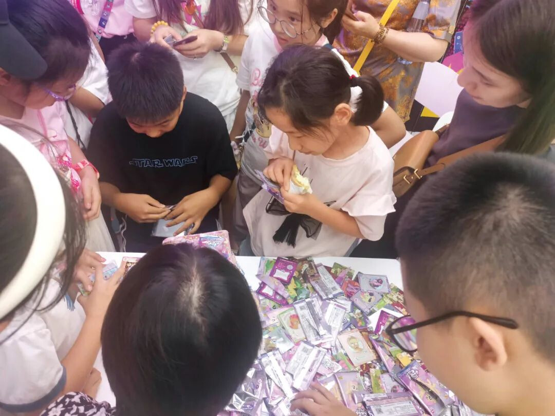 Image of a crowd watching "Box Opening"—buying entire boxes of packs and opening them