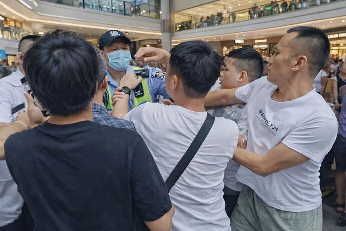 Workers and police physically clash