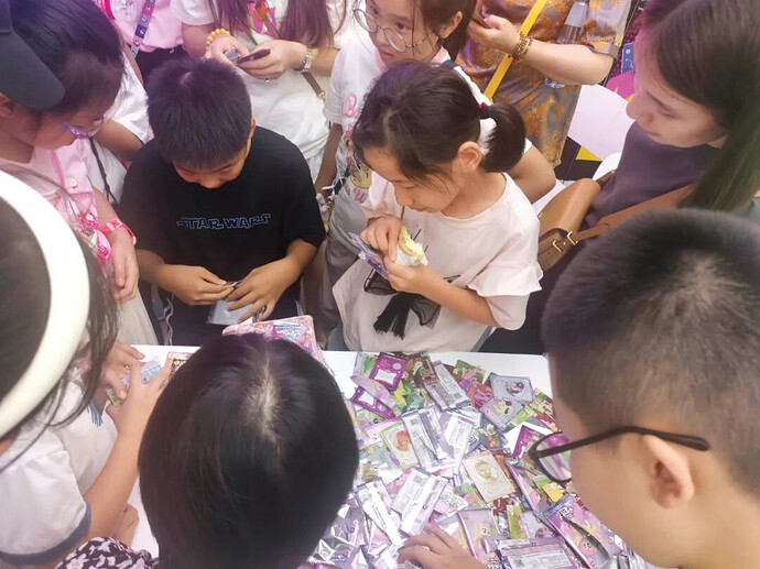 Image of a crowd watching "Box Opening"—buying entire boxes of packs and opening them